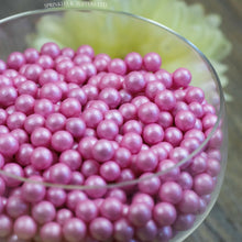 Load image into Gallery viewer, Lovely pink edible sugar pearls with shiny finish 7mm (approx)  Perfect to decorate cupcakes, a large cake, ice creams, smoothies, cookies.....the list is endless  Packaged in sealed food safe bag