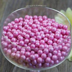 Lovely pink edible sugar pearls with shiny finish 7mm (approx)  Perfect to decorate cupcakes, a large cake, ice creams, smoothies, cookies.....the list is endless  Packaged in sealed food safe bag