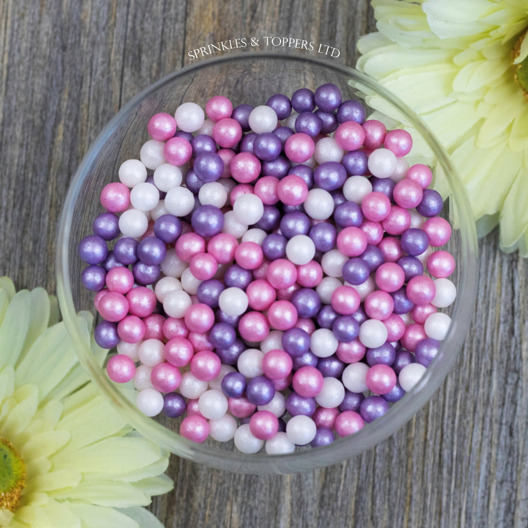 Lovely pink, purple and white edible sugar pearls with shiny finish 7mm (approx)  Perfect to decorate cupcakes, a large cake, ice creams, smoothies, cookies.....the list is endless  Packaged in sealed food safe bag