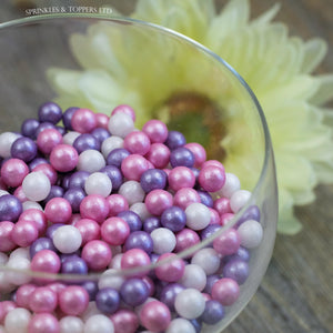 Lovely pink, purple and white edible sugar pearls with shiny finish 7mm (approx)  Perfect to decorate cupcakes, a large cake, ice creams, smoothies, cookies.....the list is endless  Packaged in sealed food safe bag
